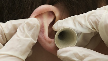 How is ear wax produced in the body?
